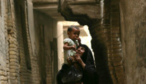 A woman holds her child from Iraq